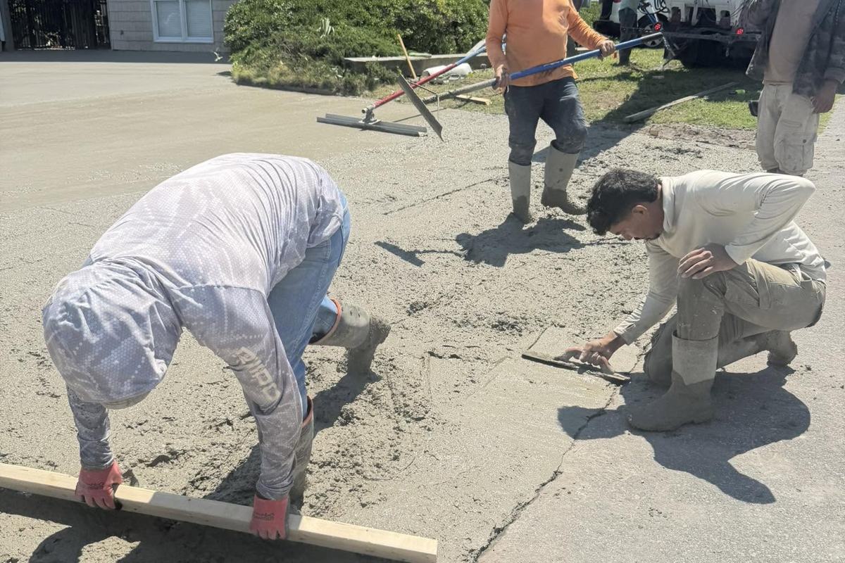 Crew leveling a fresh concrete pour